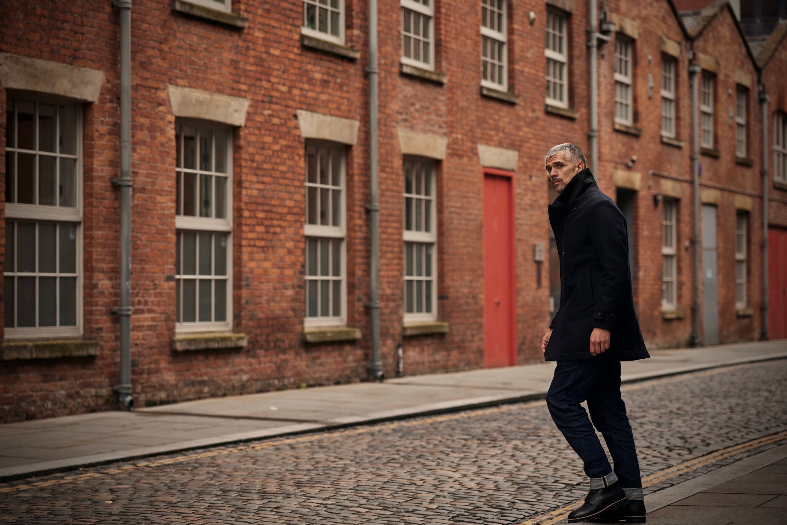 Man in FRAHM Peacoat on street in Manchester
