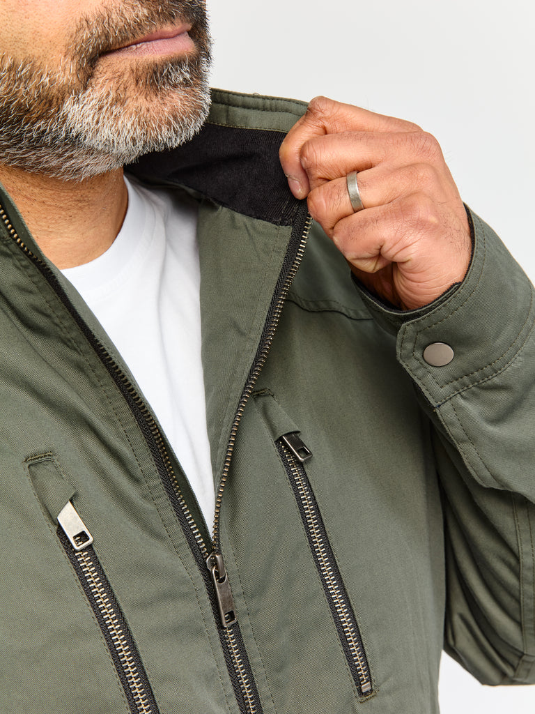 Close up of model wearing FRAHM Quilted Harrington Jacket 2026 Sage Green showing collar details