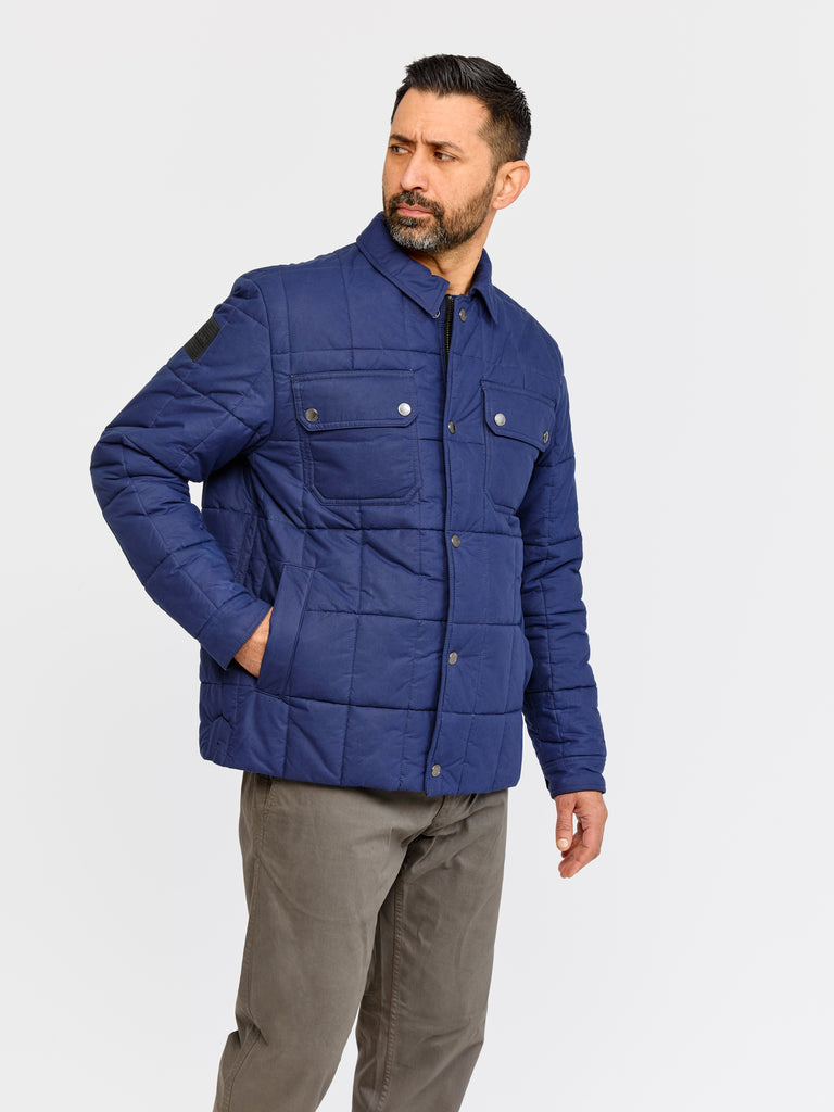 Model wearing FRAHM Quilted Winter Workers Jacket 2026 Dark Navy in studio