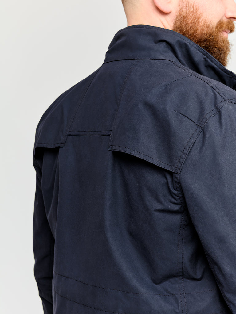 Close up of back of model wearing FRAHM Waxed Classic Field Jacket 2026 in Classic Navy