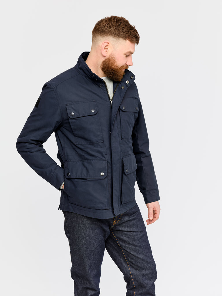 Model wearing FRAHM Waxed Classic Field Jacket 2026 Classic Navy in studio