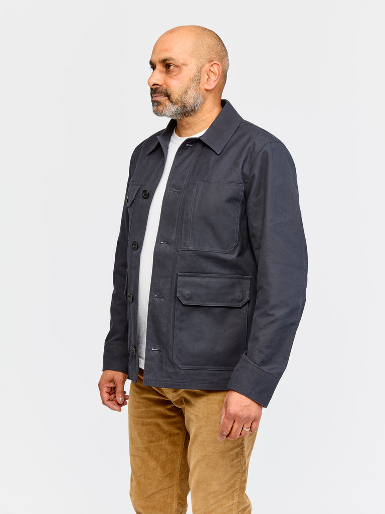 Model wearing FRAHM Waxed Woodland Workers Jacket 2026 Dark Navy in studio