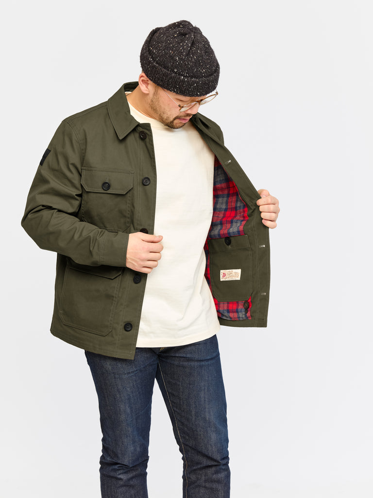 Model wearing FRAHM Waxed Woodland Workers Jacket 2026 Military Green showing inner fabric details