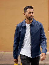 Model wearing FRAHM Lightweight Blouson Jacket in Classic Navy over white t-shirt