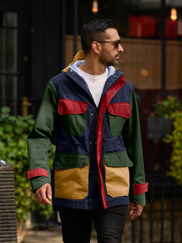 Model wearing FRAHM Waxed Hooded Field Coat 2027 Technicolour outdoor