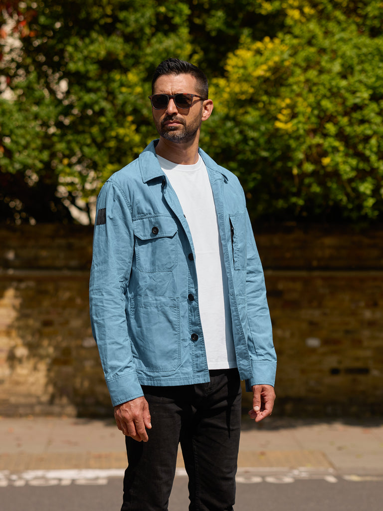 Model wearing FRAHM Waxed Lightweight Workers Jacket 2027 Turquoise outdoors