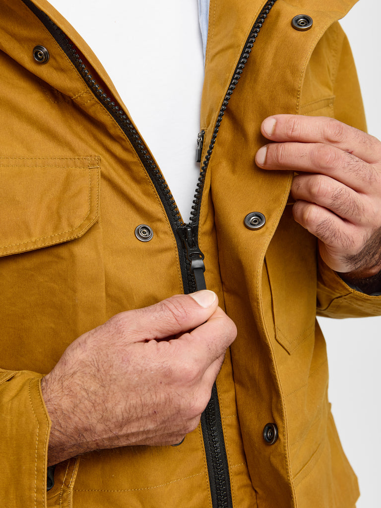 Detail of stitching and zipper on FRAHM Waxed Hooded Field Coat in Honey Tan