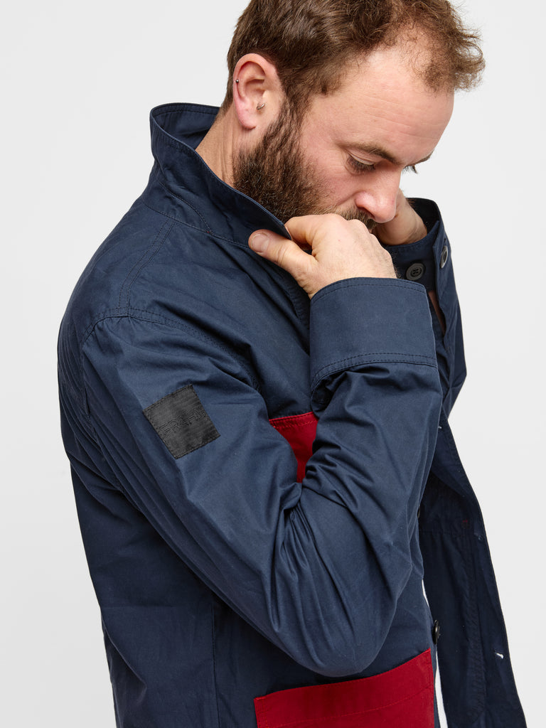 Close up of model wearing FRAHM Waxed Lightweight Workers Jacket 2027 Dark Navy with Red showing collar detail