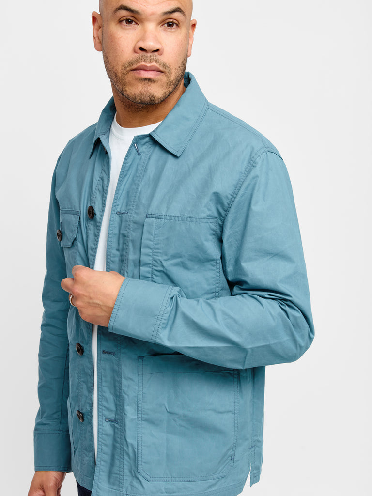 Model wearing FRAHM Waxed Lightweight Workers Jacket 2027 Turquoise in studio