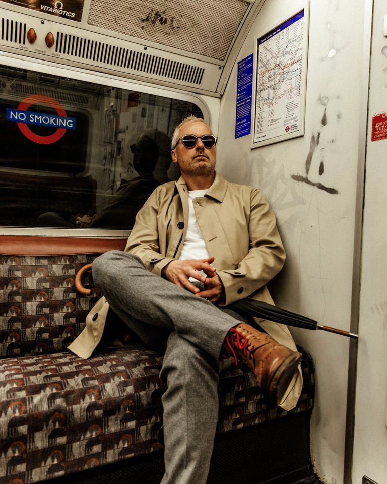 Model wearing FRAHM Classic Trench Coat 2027 in Beige on London Underground