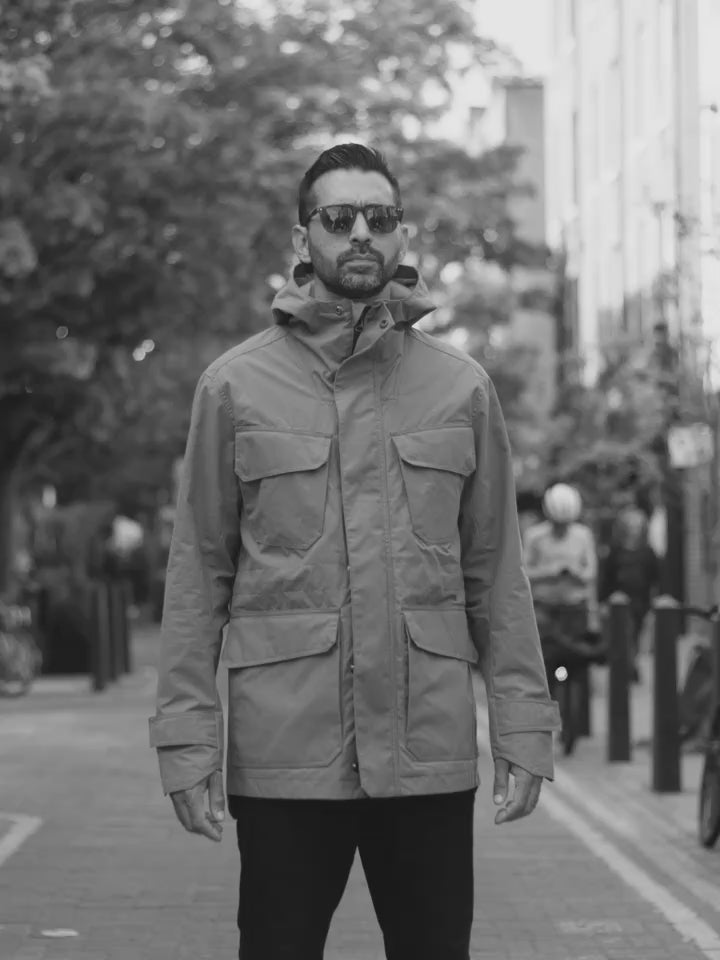 Model wearing FRAHM Waxed Hooded Field Coat showing jacket details